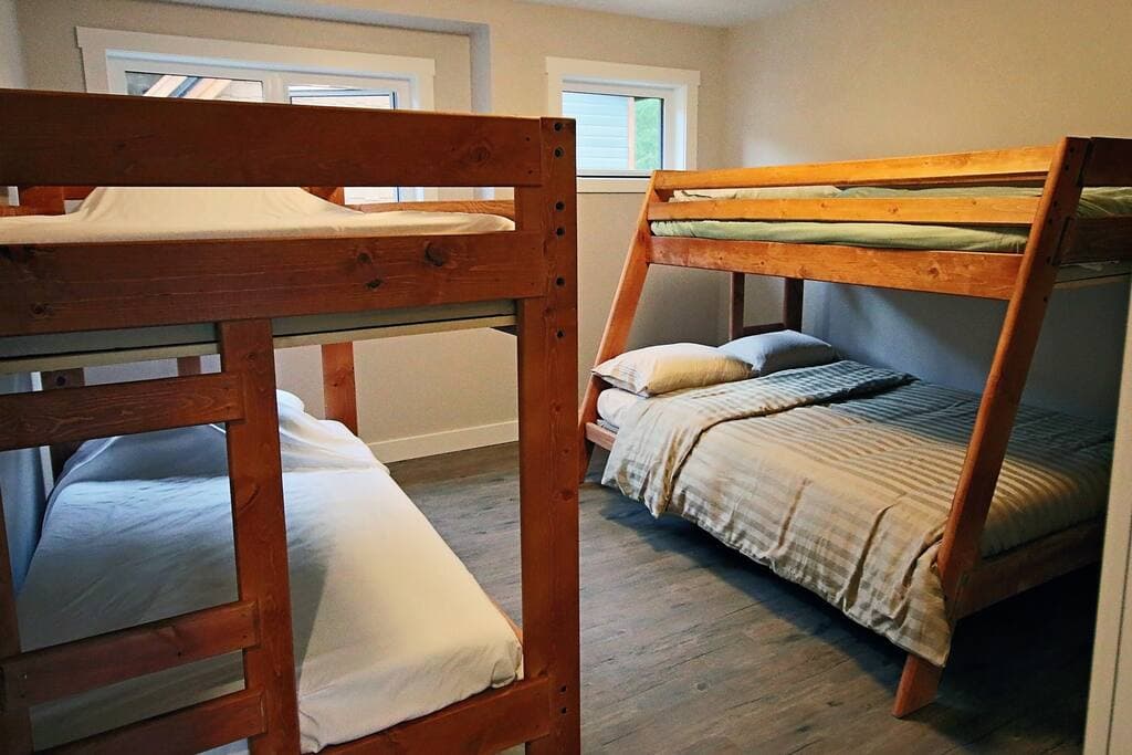 Bunk room with two timber bunk beds: a twin over a double, and a twin over a twin