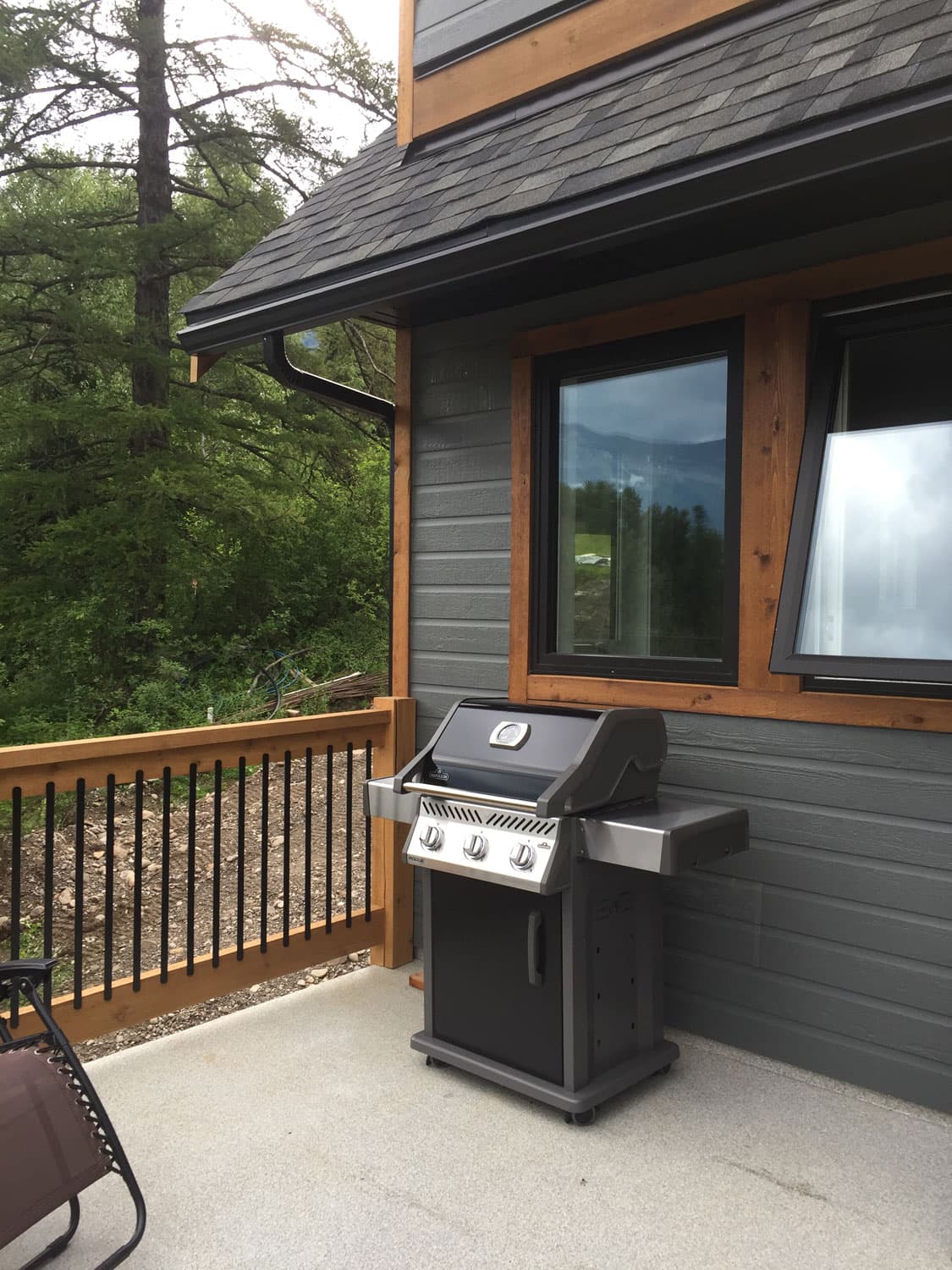 Gas BBQ on the covered corner of the deck beside the kitchen window