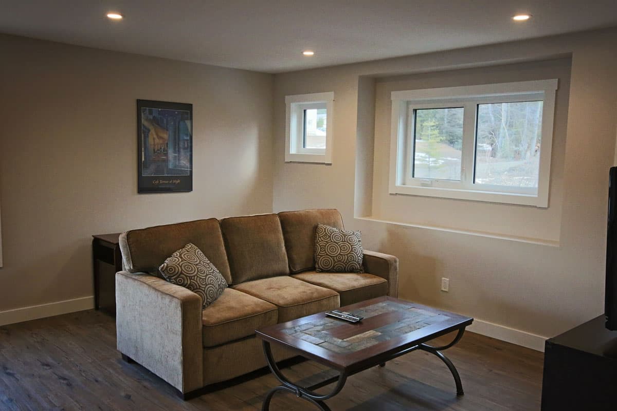 Lounge corner of the games loft: sofa, slate-topped coffee table and TV