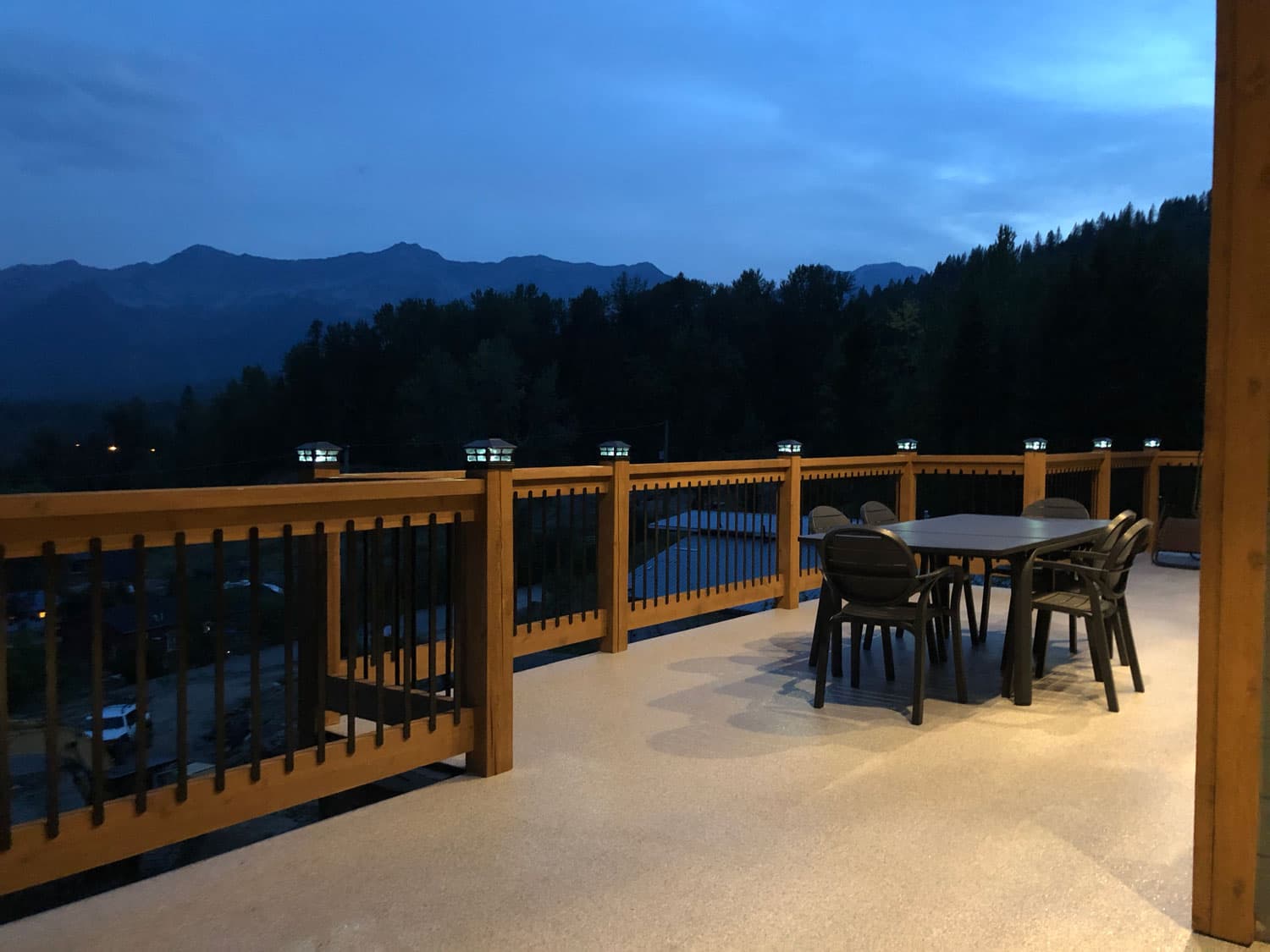 The deck at dusk, post-cap lights glowing, with the Lizard Range silhouetted against the evening sky